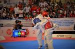 male Para taekwondo fighter Juan Garcia Lopez kicks another fighter around the back
