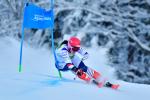 female Para alpine standing skier Marie Bochet turns round a gate as she skis down the slope