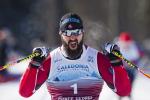 male Para Nordic skier Collin Cameron yells with joy as he crosses the finish line