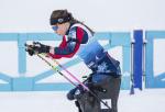 female Para Nordic skier Oksana Masters drives her ski poles through the snow