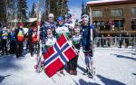 Group of Norwegian cross-country skiers happy posing together after a win