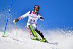 male Para alpine skier Martin Wuerz turns through a gate