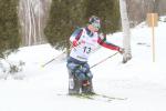female Para Nordic sit skier Oksana Masters turns round a bend in the course