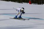 male Para alpine standing skier Roger Puig Davi crouches down as he crosses the finish line