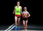 female vision impaired runner Misato Michishita running on the street with a male guide