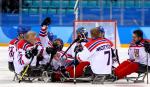male Para ice hockey players from Czech Republic celebrating and hugging on the ice