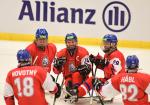 a group of Czech Para ice hockey players celebrating on the ice