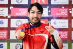 male Para swimmer Takayuki Suzuki holds up his gold medal