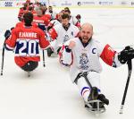male Para ice hockey players from Czech Republic smiling and punching the air on the ice