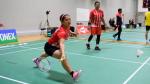 Indonesian female badminton player lunges for the birdie