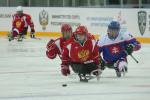 Two Russia Para ice hockey players and one Slovakian race for the puck