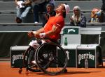 Argentinian wheelchair tennis player Gustavo Fernandez celebrates screaming at the sky after winning Roland Garros