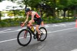 Female British triathlete with arm impairment rides her bike