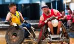 male wheelchair rugby player Stefan Jansson tackles another player