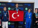 Woman taekwondo fighter on the podium holding the Turkey flag