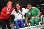 three female powerlifters on the podium