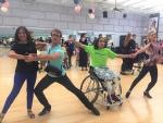Two pairs of Para dance couples pose in a dance studio