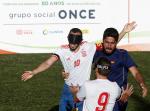 three male blind footballers including two from Spain battle for the ball
