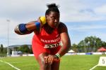 A young woman competing in shot put