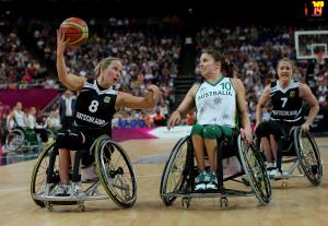 A picture of two women in wheelchairs playing basketball
