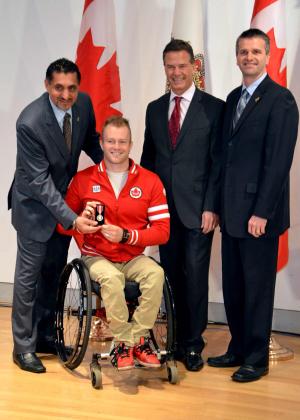 Canada's Josh Cassidy receives the Queen Elizabeth II Diamond Jubilee Medal