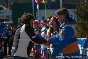 A picture of a woman celebrating her victory during a medal ceremony.