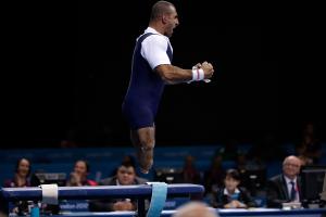 Ali Jawad of Great Britain leaps into the air after making a successful lift in the men's -56 kg Powerlifting event.