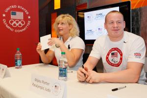 A picture of 2 people signing autographs