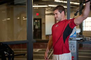 An athlete works out his shoulders in the gym.
