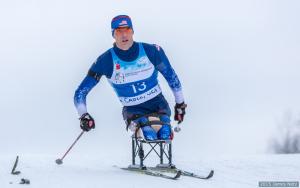 Man in sit ski doing cross country skiing