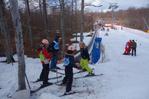 A group of youngsters are taught how to ski