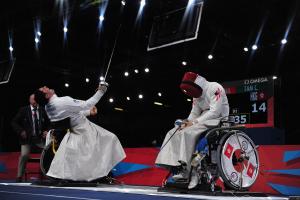 Athletes practicing wheelchair fencing.