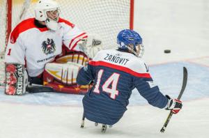 Marek Zanovit of Slovakia at the goal of Team Austria in the bronze medal game at the 2015 IPC Ice Sledge Hockey World Championships B-Pool in Ostersund, Sweden.
