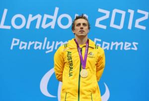 A picture of a man standing with a gold medal around his neck