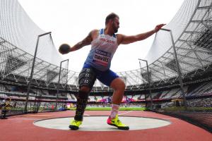 Man in discus cage throwing