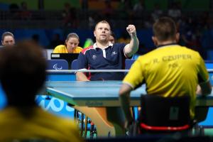 male Para table tennis player Fabien Lamirault punches the air after a shot